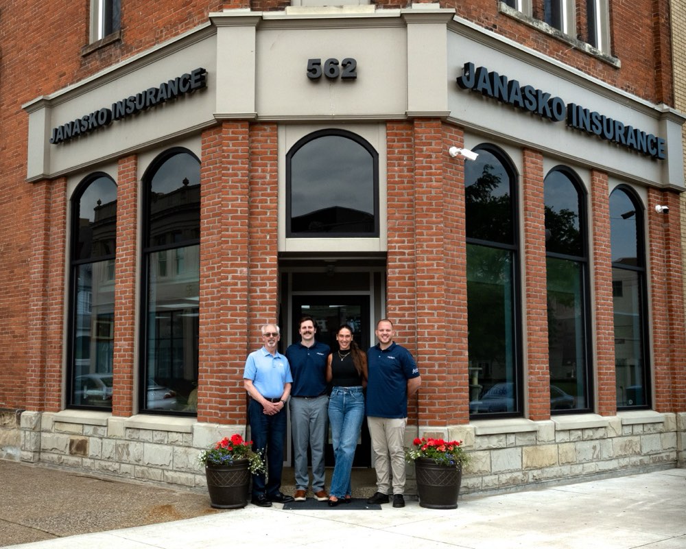 The Janasko Insurance team outside their brick storefront